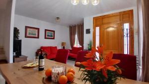 a living room with a table with oranges on it at Chalet Campoamor con piscina privada in Orihuela Costa