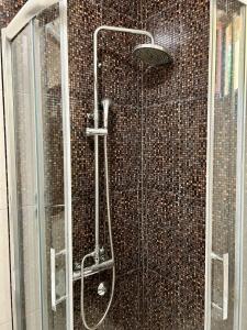 a bathroom with a shower with a glass door at Casablanca in Sutomore