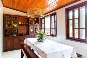 a kitchen with a table and some windows at SA · Beachfront Saquarema: Your beach house! in Saquarema