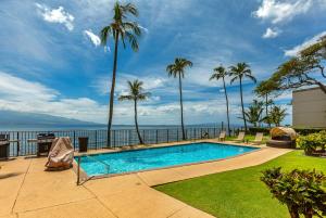 a swimming pool with a view of the water at Lauloa 407 by Coldwell Banker Island Vacations in Wailuku