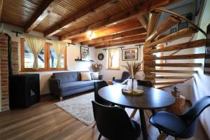 a living room with a table and a couch at House Forest with HOT TUB in Otočac