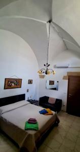 a bedroom with a bed and a chandelier at Via Cufra 46 in Botrugno