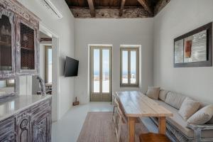 a living room with a couch and a table at My Secret Mojo 2 in Serifos Chora