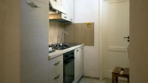 a small kitchen with a stove and a sink at B&B Al Duomo in Mola di Bari