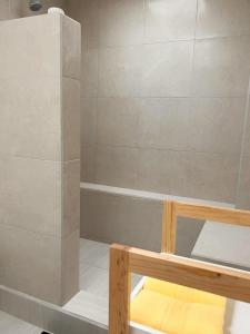 a bathroom with a shower with a bench in it at Habitacion Berlin en The Green Door in Aguascalientes +14 photos