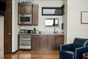 a kitchen with wooden cabinets and a sink at Romantic Lake Retreat - Deck, BBQ Grill & Patio in Spicewood