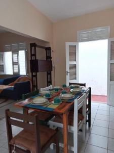 a dining room with a table with plates on it at Casa Verde Marinho - Sossego no Jacarecanga in Fortaleza