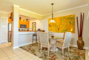 a kitchen and dining room with a table and chairs at Grand Champions 145 by Coldwell Banker Island Vacations in Wailea
