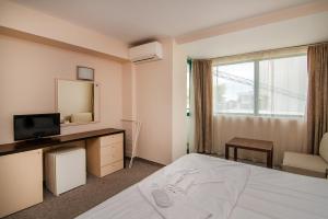 Ένα ή περισσότερα κρεβάτια σε δωμάτιο στο Budget Beachfront Golden sands