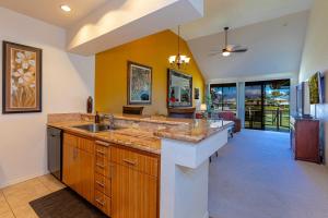 a large kitchen with a sink and a counter at Grand Champions 164 by Coldwell Banker Island Vacations in Wailea