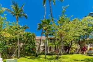 a house with palm trees in front of it at Grand Champions 164 by Coldwell Banker Island Vacations in Wailea