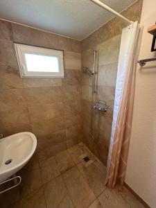 a bathroom with a shower and a sink at Cozy little chalet in a perfect location! in Champéry +9 photos