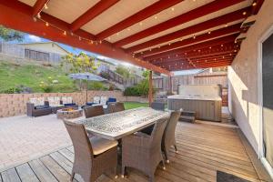 a patio with a table and chairs and an umbrella at Spacious 4BR Oasis with Pool Table and Spa in San Diego