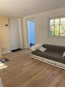 a living room with a bed and a window at AUX PETITS BAGANAIS in Lacanau