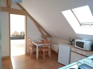 a small kitchen with a table and a microwave at Cosne-sur-Loire Appartement Centre Ville in Cosne-Cours-sur-Loire