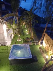 a hot tub in the yard of a house at night at Villa Panorama Isola di Ischia in Ischia