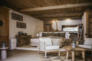 a bedroom with a bed and a table and chairs at Lagnonu in Verghia