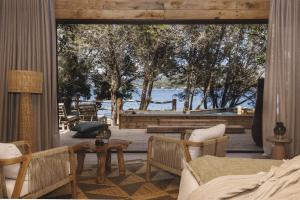 a living room with a deck with a table and chairs at Lagnonu in Verghia