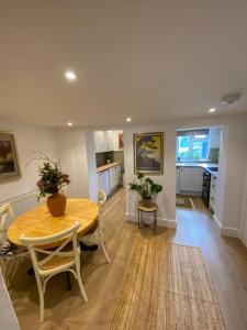 a living room with a table and a kitchen at 5 chapel lane Wymondham Norfolk in Wymondham