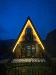 a house with lights on the side of it at Tara lux in Mojkovac