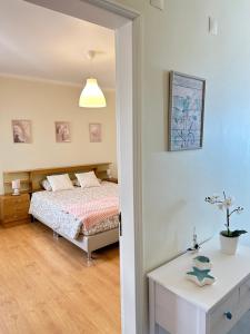 a bedroom with a bed and a table at Face a l'océan - Praia da areia branca, vue mer in Praia da Areia Branca