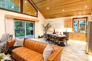 a living room with a couch and a table and a kitchen at Swiss Marmot in Glacier