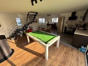 Una sala de estar con una mesa de ping pong. en Les maisons Inael, en Pénestin 5 fotos más