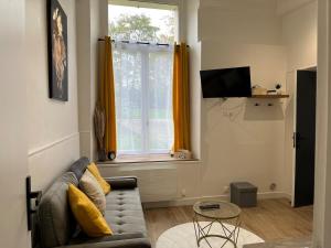 a living room with a couch and a window at Appartement Rozay en brie in Rozay-en-Brie