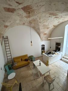 a living room with a couch and a table at Casa Camelia - Elegant Palace with Terrace - Conversano in Conversano