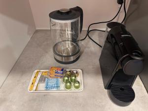 a food processor and a blender on a counter at Cozy Studio Apartment in Dubai
