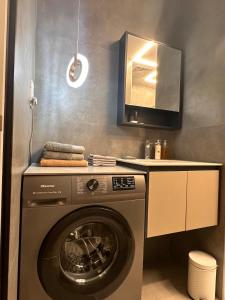 a washing machine in a kitchen with a counter at Cozy Studio Apartment in Dubai