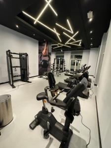 a row of exercise bikes in a gym at Cozy Studio Apartment in Dubai +15 photos