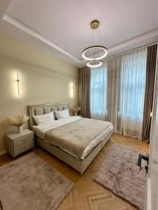 a bedroom with a bed and a large window at Central View Apartment in Turda