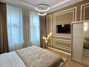 a bedroom with a bed and a television in it at Central View Apartment in Turda