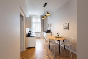 a kitchen and dining room with a table and chairs at Evita7 in Gniezno