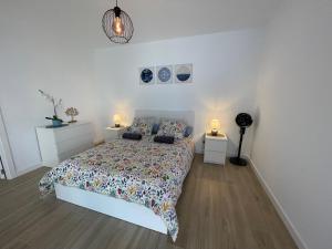 Un dormitorio con una cama con dos mesitas de noche y dos lámparas. en Casa Emma, en Villaverde 23 fotos más