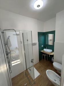 a bathroom with a shower and a toilet and a sink at Casa Camelia - Elegant Palace with Terrace - Conversano in Conversano