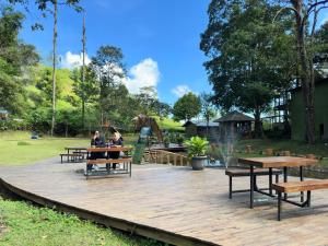 two people sitting at picnic tables in a park at Telaga Warna in Tengahgirang