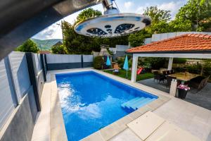 a swimming pool in the backyard of a house at Kameni Dvori in Imotski
