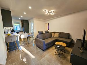 a living room with a couch and a kitchen at Stressless Nin in Nin