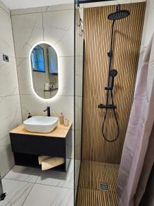a bathroom with a sink and a shower at Stressless Nin in Nin +13 photos