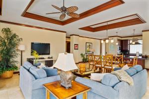 a living room with two blue couches and a table at Big Island Waiulaula at Mauna Kea J201 by Coldwell Banker Island Vacations in Hapuna Beach