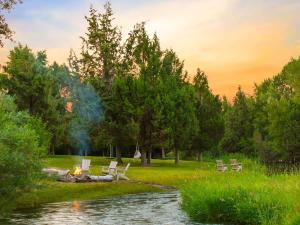 a fire pit in a park next to a river at Private Island Fire Pit & Arcade in Rigby