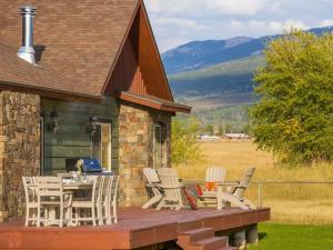a wooden deck with chairs and a table on a house at Family Fun Fireplace & Huge Deck in Victor
