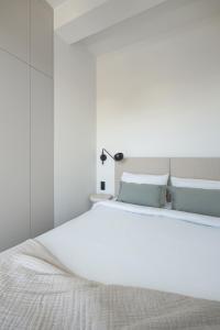 a bedroom with a large white bed with blue pillows at Stone Suite Zakopane in Zakopane +44 photos