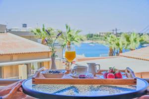 a table with a tray of food and a glass of wine at Anatoli Apartments in Agia Pelagia +50 photos