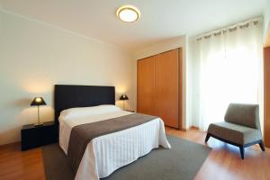 Cama ou camas em um quarto em Real Marina Residence