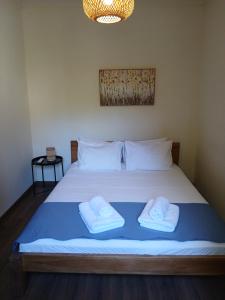 a bedroom with a bed with two towels on it at Mountain and Sea view in Miléai