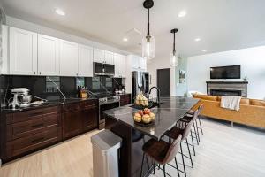 a kitchen and living room with a table and chairs at Unique Townhome with AC Garage Patio in Driggs