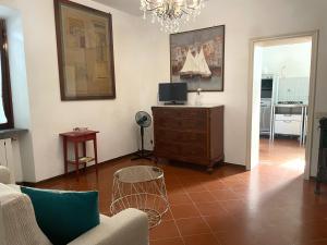 a living room with a couch and a tv on a dresser at 'Il Casale di Giova' Tuscan Farmhouse in Lucca